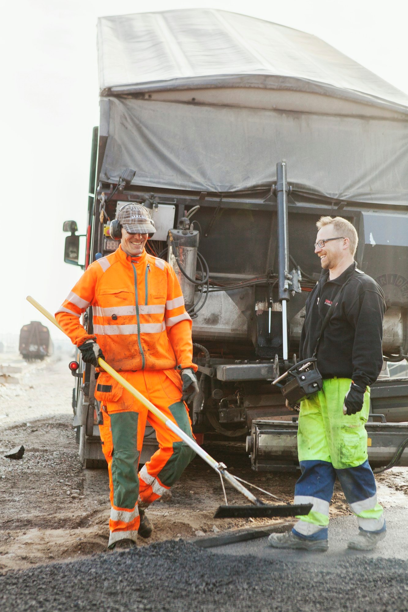 Manual workers paving at road construction site