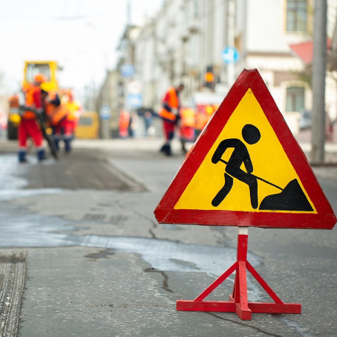 Warning street sign on road work site.